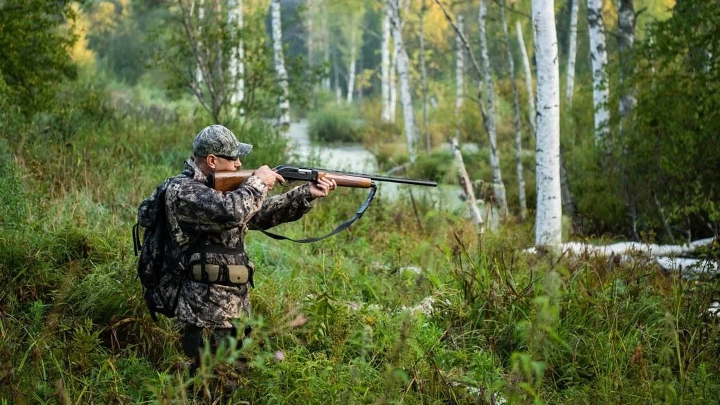 Hunter working a flooded bottom, far enough from the truck that the first cuts matter
